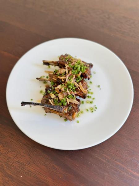 Sticky Lamb Riblets with house-fermented chilli, pomegranate molasses glaze & chives.